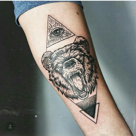Tatuaje en el brazo, oso y ojo que todo lo ve